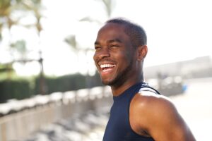 a man outside smiling and experiencing the men's mental health program benefits
