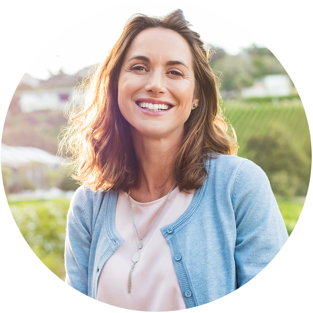 a photo of a woman smiling while outside