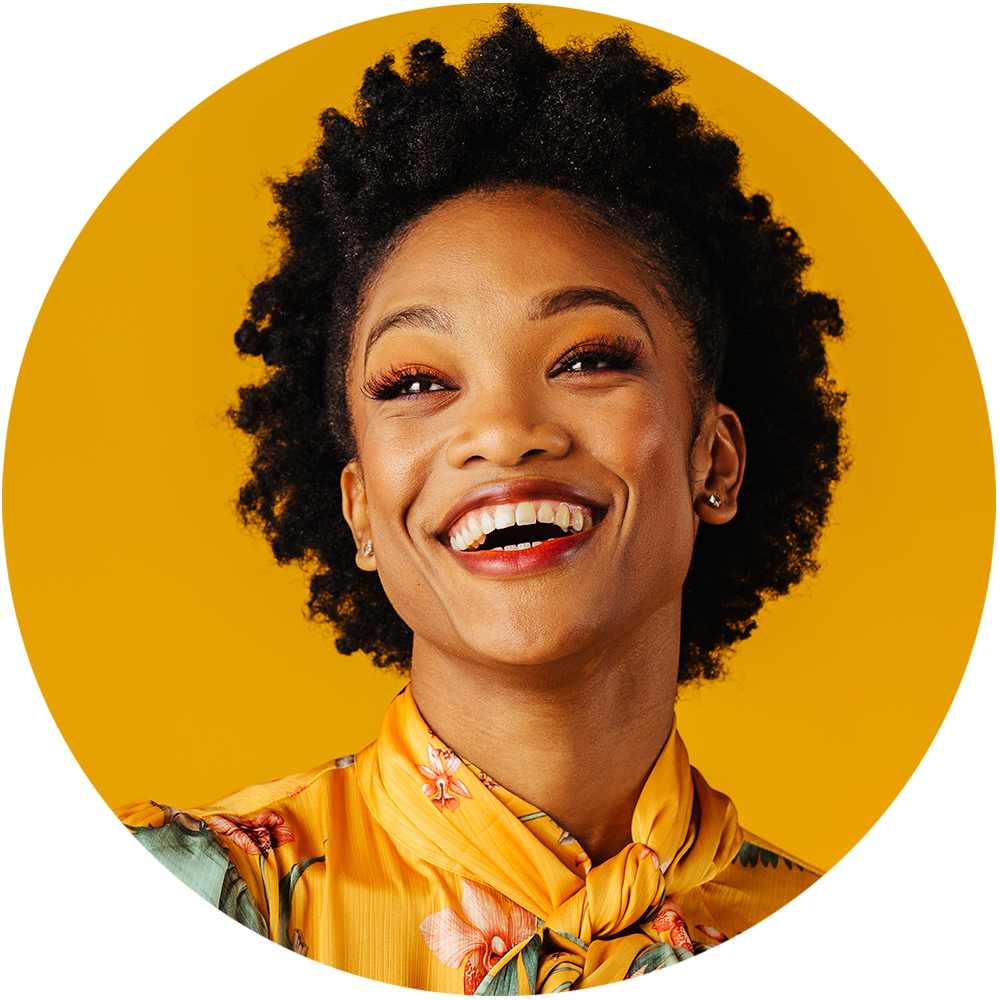 a photo of a woman wearing yellow and smiling while looking off into the distance