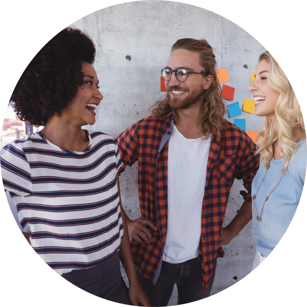 three people stand together and smile at each other