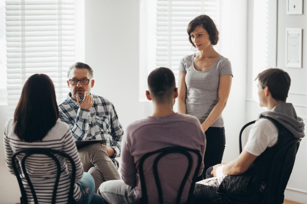 a group discusses acceptance and commitment therapy benefits