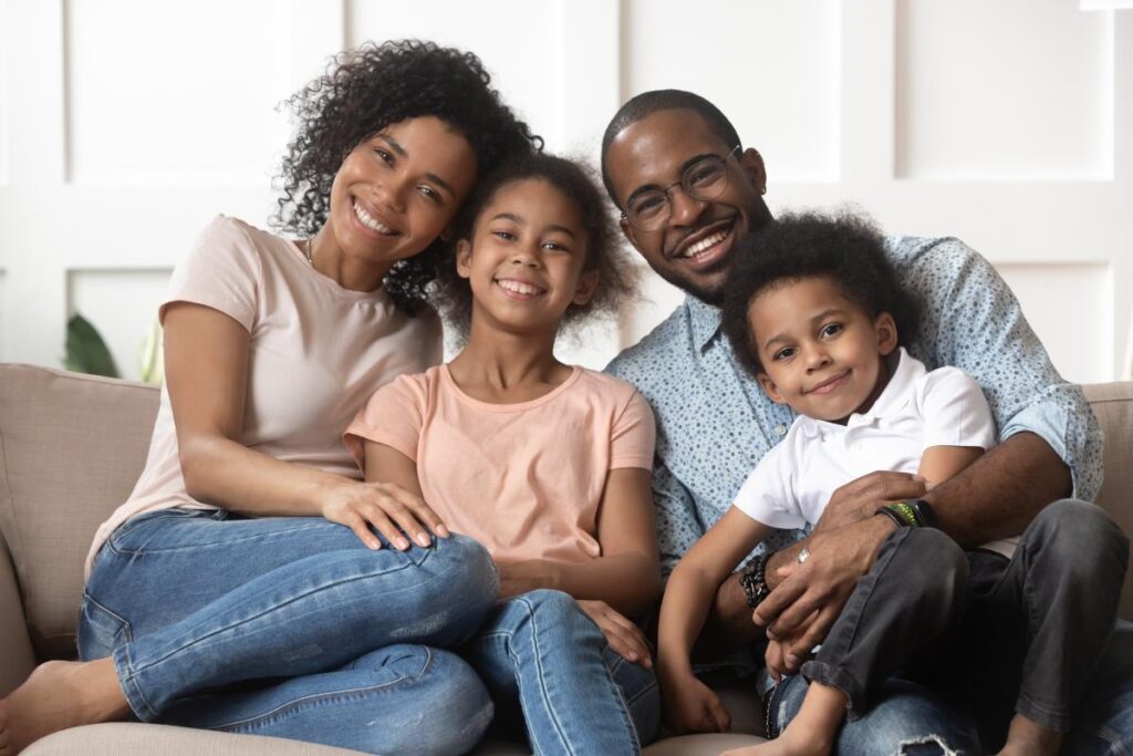 a family sits on a couch enjoying internal family systems benefits
