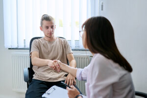 Man shaking hands with woman