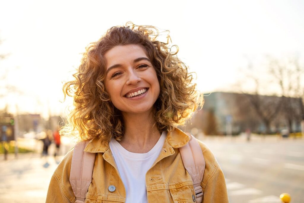a person smiles after enjoying mental health therapy benefits