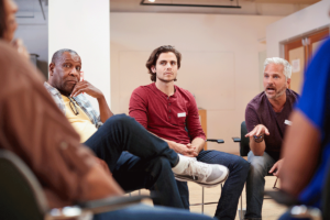 a group of men discuss the topic: why choose gender-specific treatment?