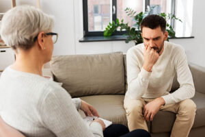 a person talks with a therapist in a stress disorder treatment program