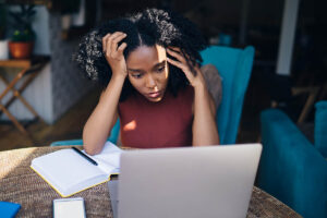 a person looks anxious while researching stress disorder definition on a computer
