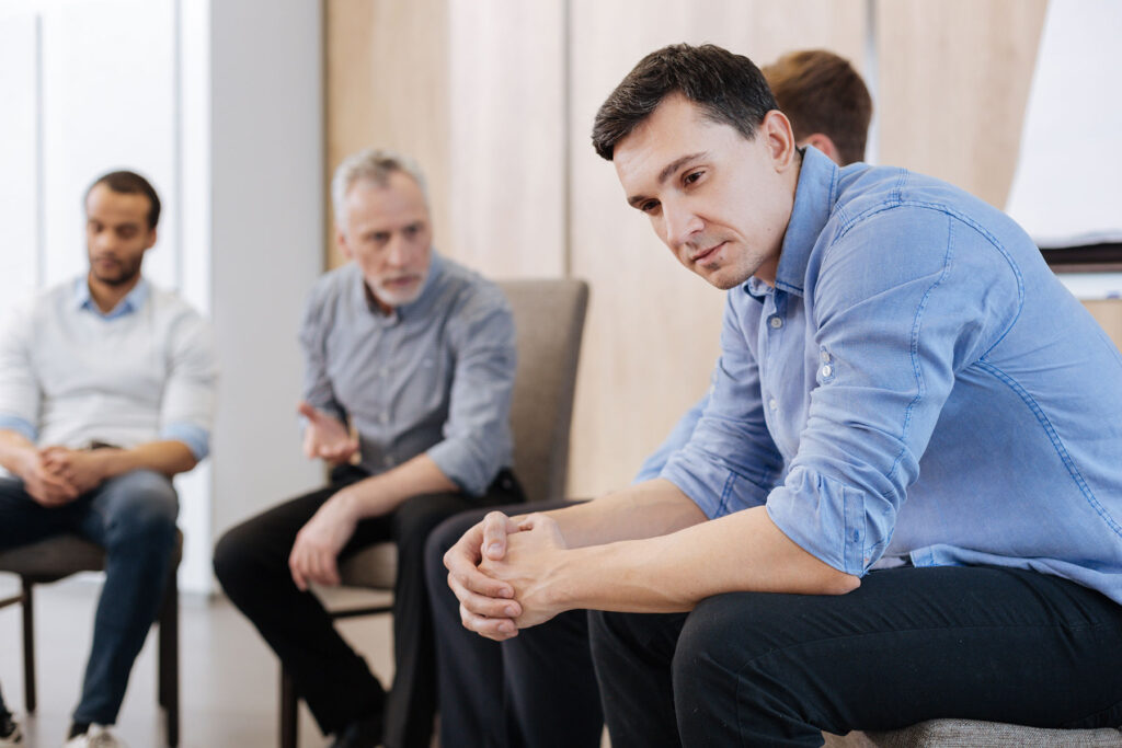 a group in therapy discuss the ability to work while in men's program