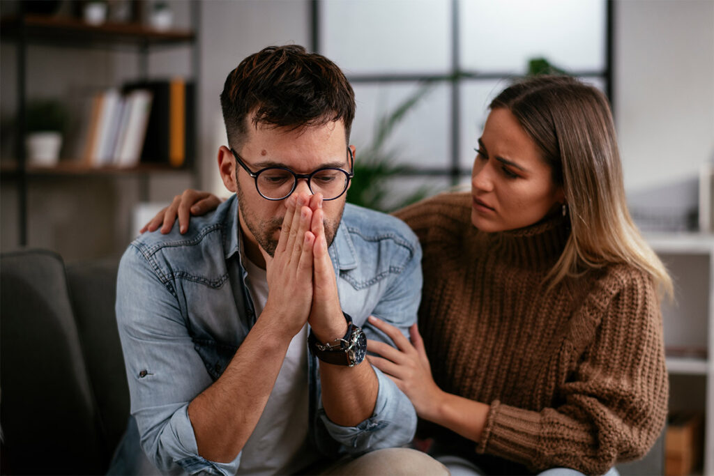 a woman supports her husband who is struggling with depression