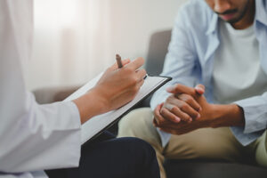 a trauma therapist listens to a client during a session