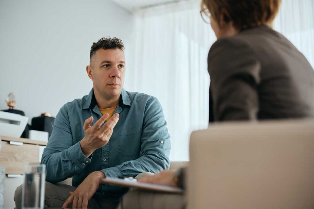 a man opens up to his counselor while in therapy during his partial hospitalization program