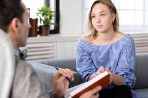 a woman makes progress in therapy after a mental health crisis
