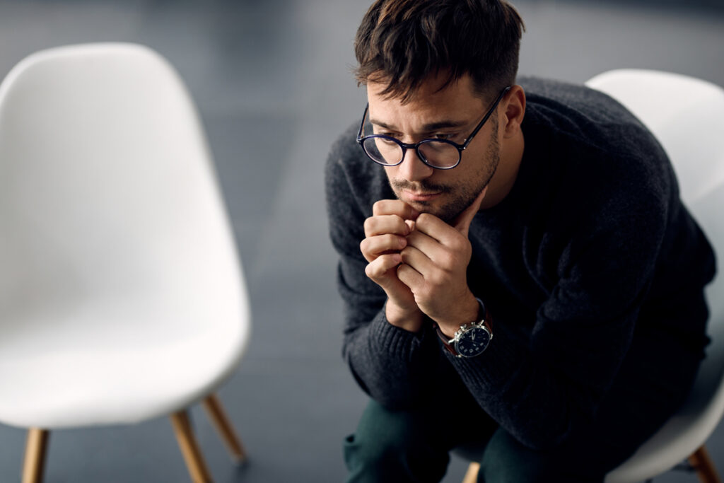 Man pensive sitting in a chair