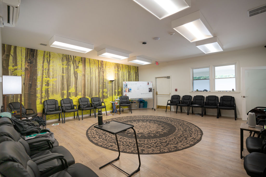 Group therapy room with forest mural at the Sharon, Massachusetts center